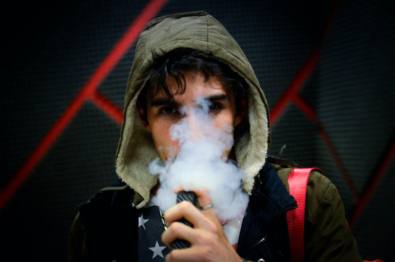 young man smoking e cig