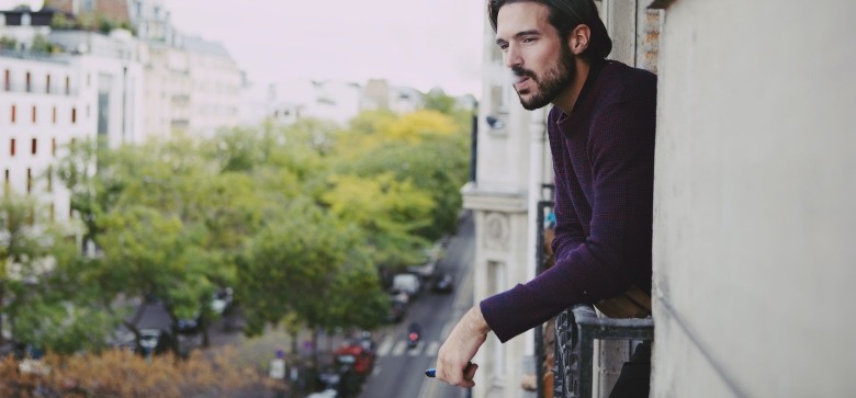 Man exhaling the vapor of electronic cigarette with nicotine