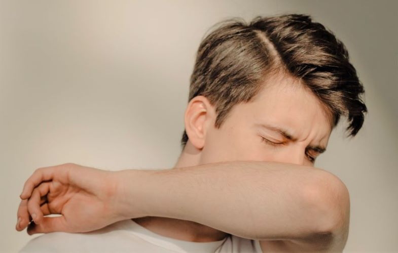 Boy coughing from throat pinching after vaping