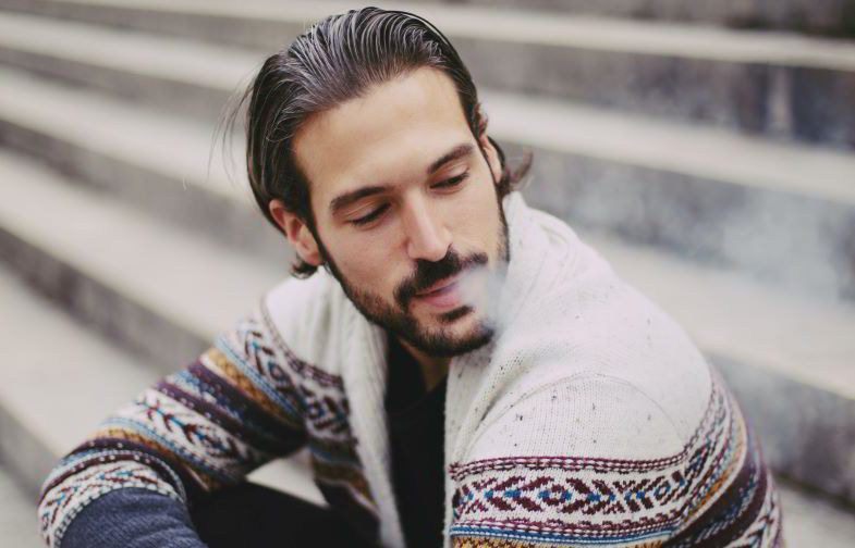 Boy vaping with an electronic pipe