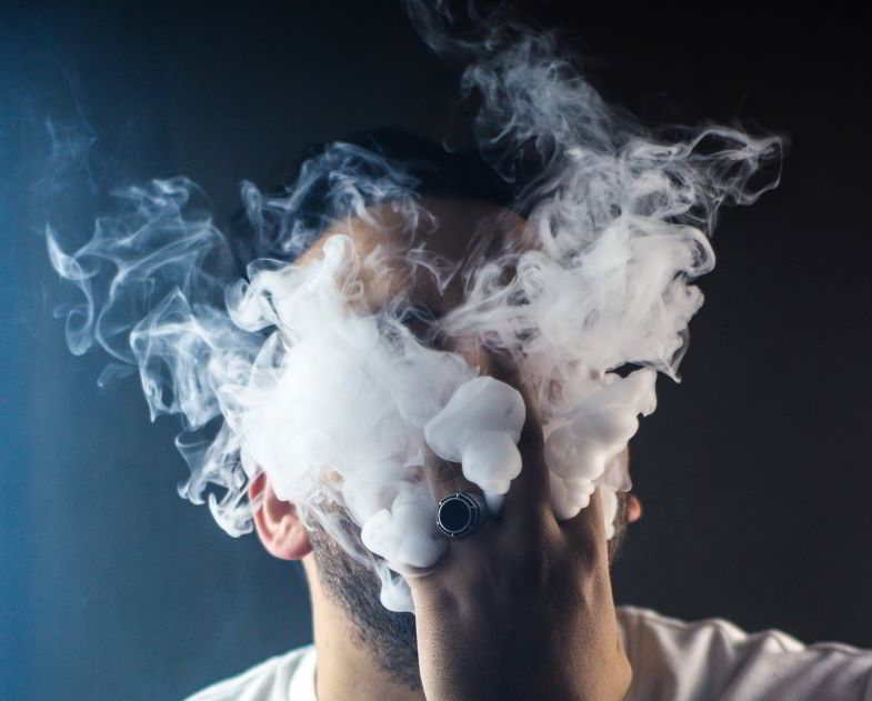 Guy inhaling vapour from lung e-cigarette