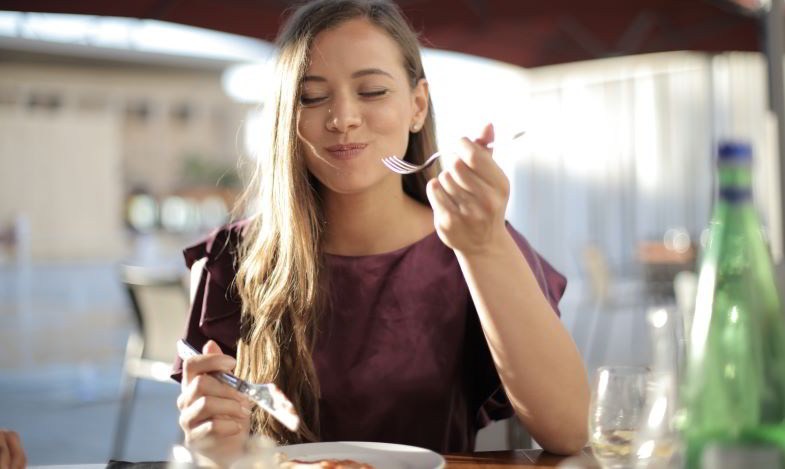 Woman who appreciates the taste and smell of food after quitting smoking