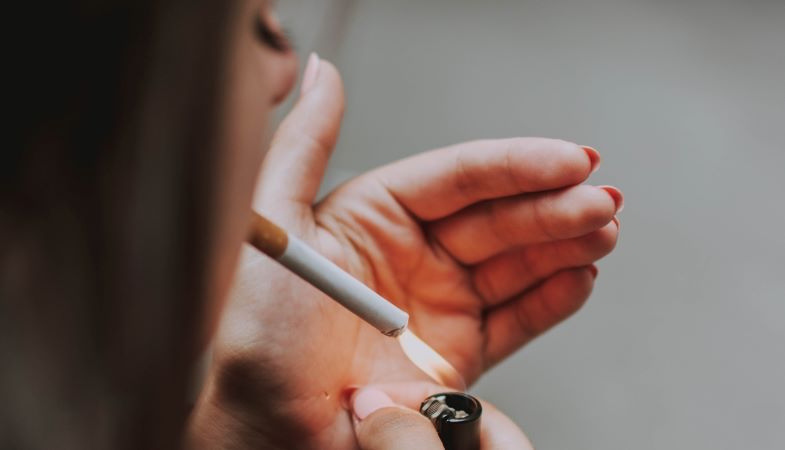 Woman lighting a cigarette