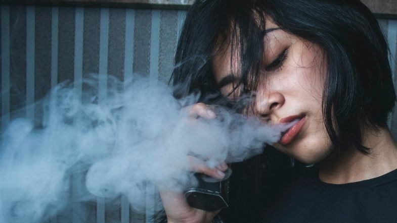 Girl vaping with a box mod