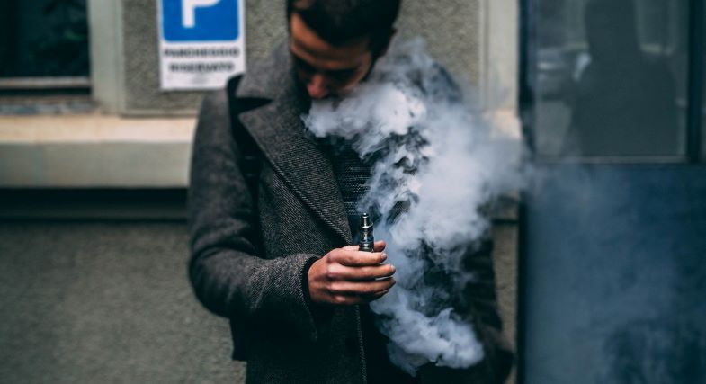 Man using e-cigarette to quit smoking