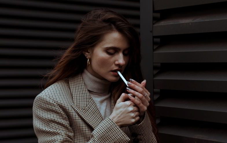 Woman lighting cigarette