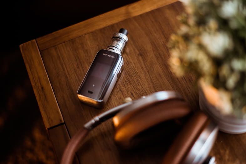 Electronic cigarette resting on a wooden coffee table