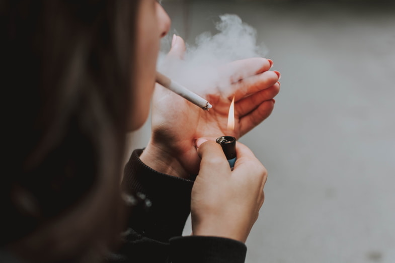 Woman lighting a cigarette