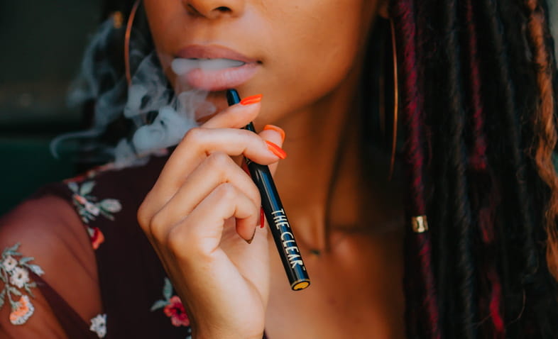 Girl vaping with a cigalike device with cartomiser